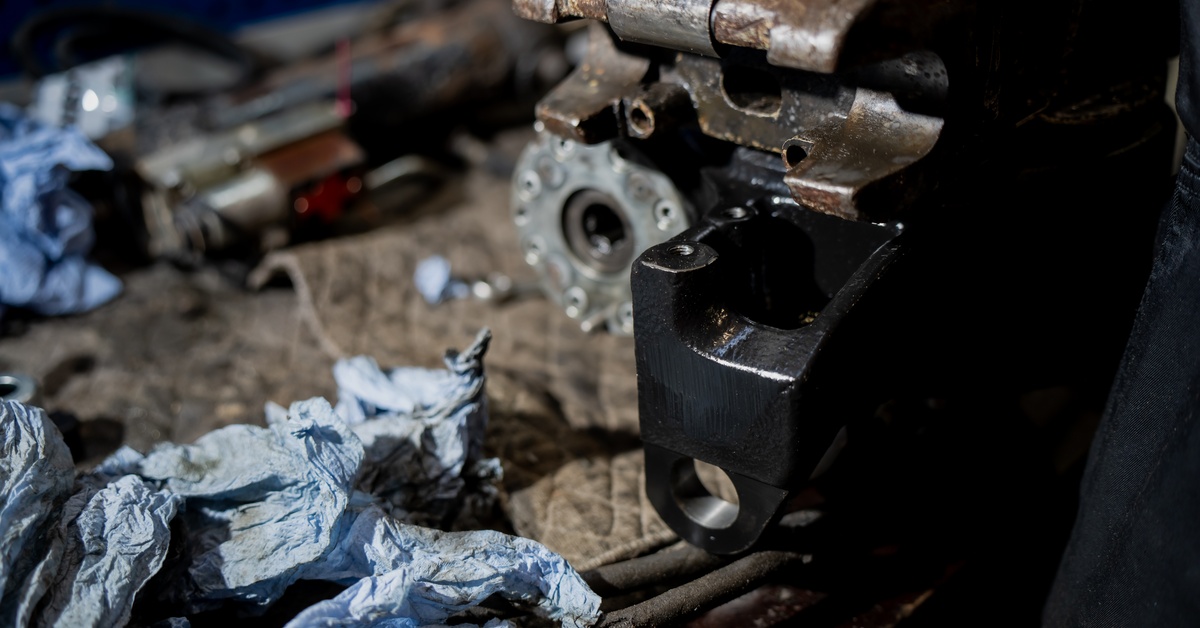 A piece of machinery with used rags next to it. The machine is dirty, and the rags also have grime on them.